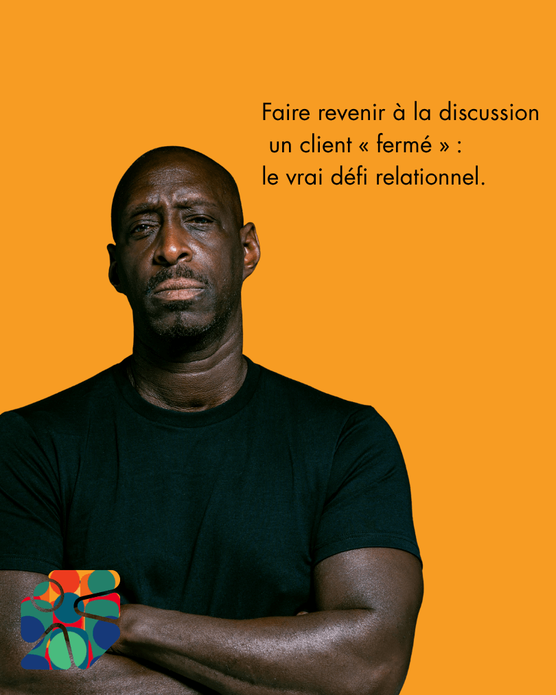 Client fermé en posture de protection, bras croisés, lors d’une interaction commerciale.