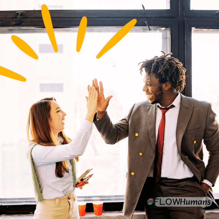 Deux professionnels se tapent dans la main pour illustrer l’assertivité, la coopération et une communication constructive au travail.